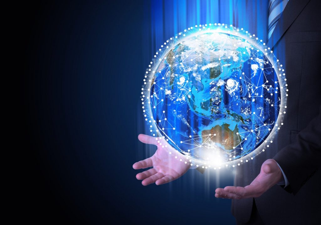 Man in suit holding a earth in hand